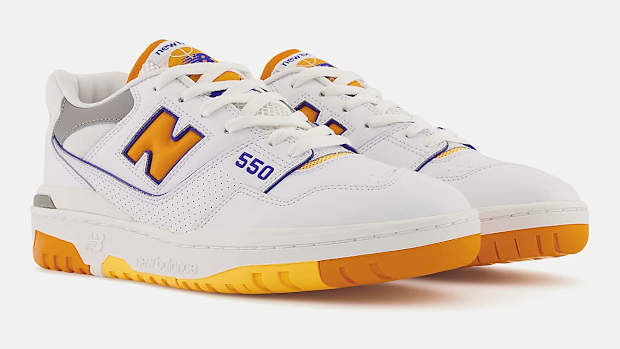 View of white, orange, purple New Balance 550 shoes.